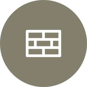 A white brick wall icon is centered on a circular gray-brown background.