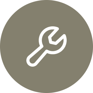 A white wrench icon on a gray circular background.